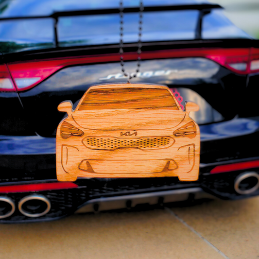 Wooden car model on the back of a black car